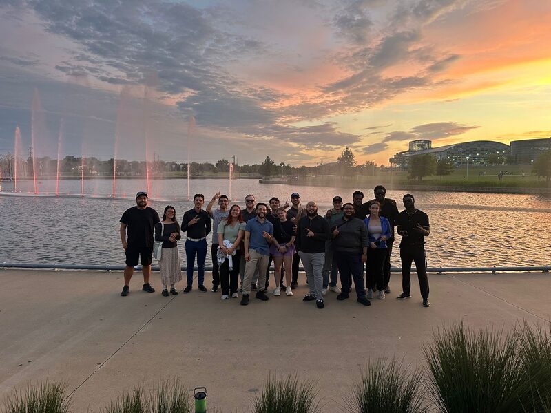 The team at an outdoor event at sunset