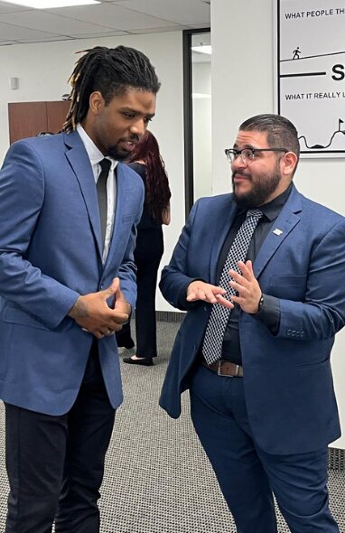 Two 5 Pillar Solutions team members in conversation at the office