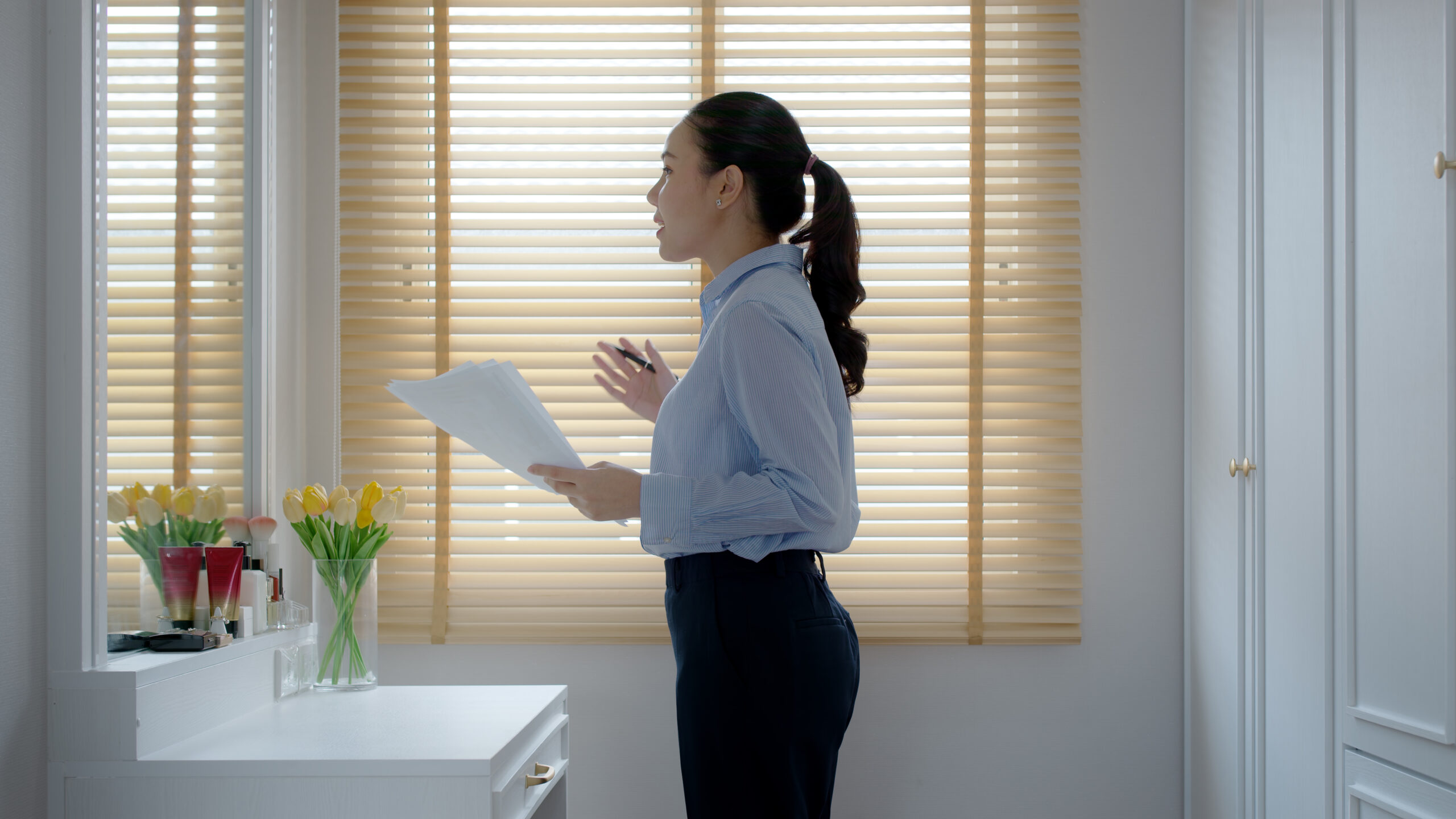 Young professional practicing her pitch in front of a mirror