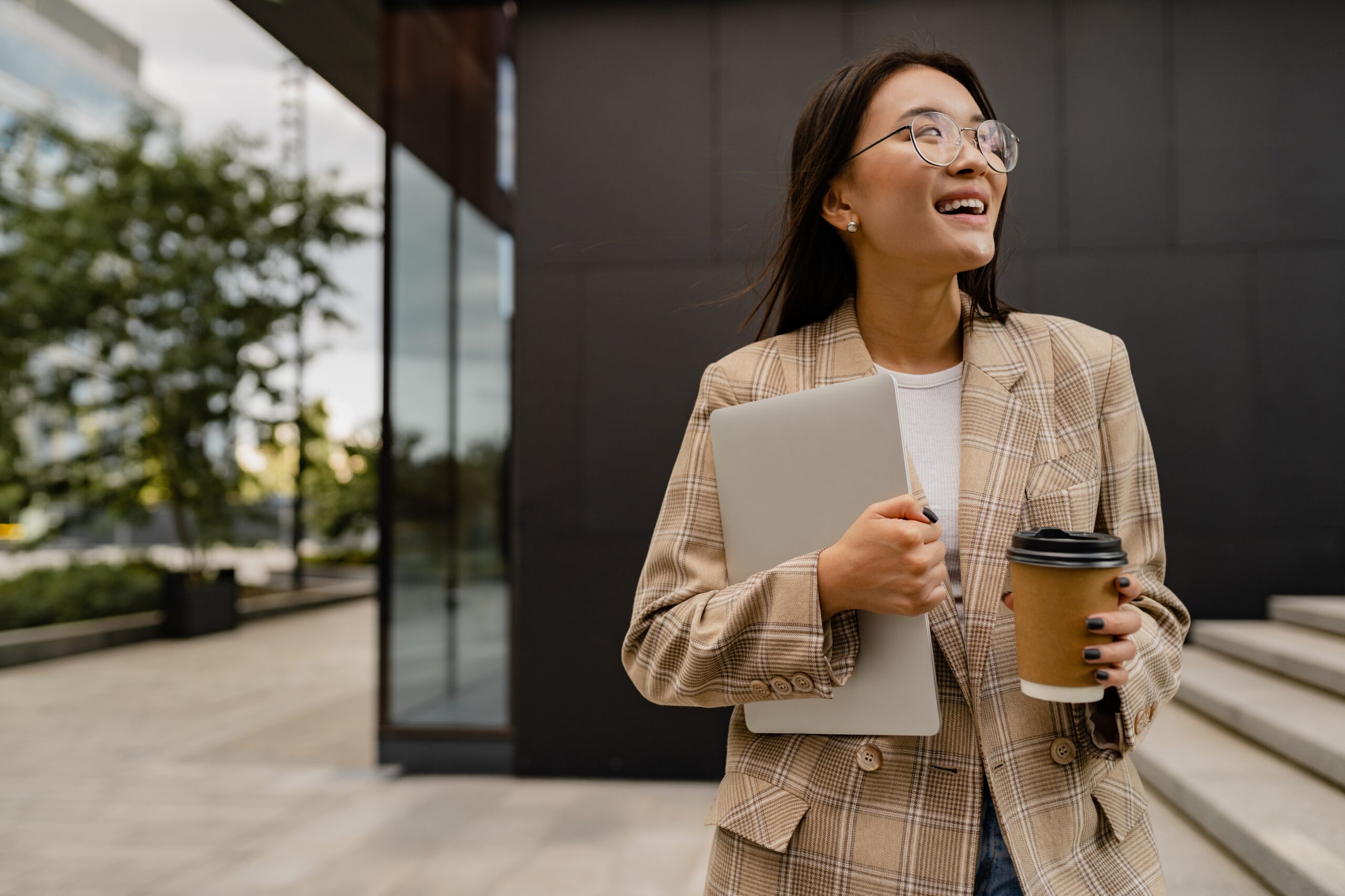 A young business professional looking optimistic while outside the office.